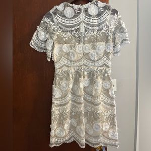 White Lacey dress from Vici. The brand is Minuet